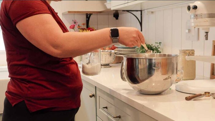 Adding dry ingredients to stand mixer bowl
