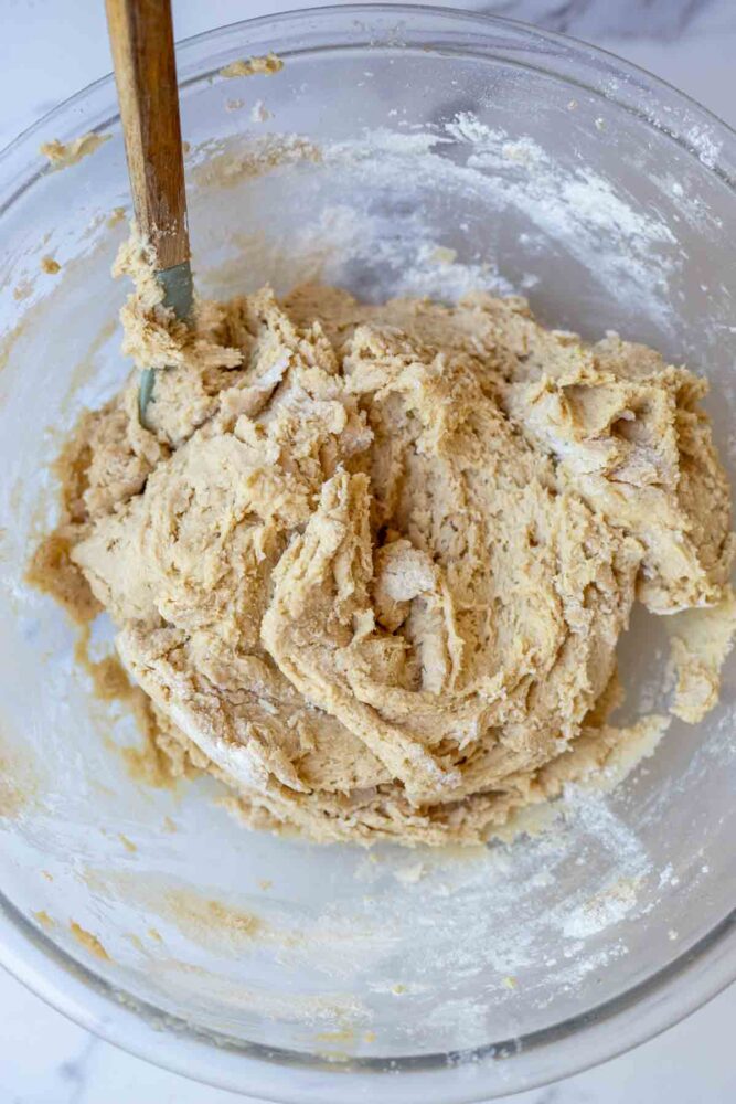 Dry ingredients added to wet ingredients to form cookie dough.