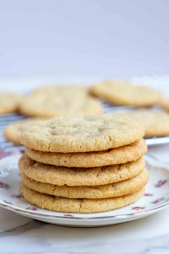 Sourdough sugar cookies stacked 5 high on a small floral plate.