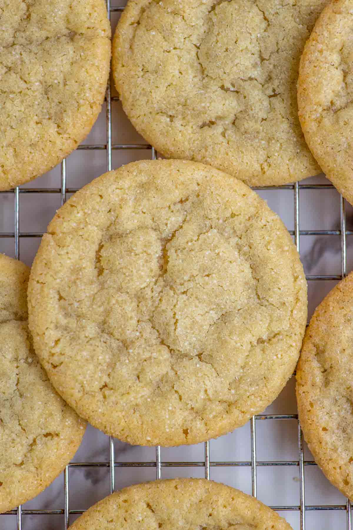 Close up of sourdough sugar cookies on a wire rack.