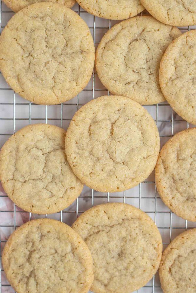 Sugar cookies stated on a wire wrack.